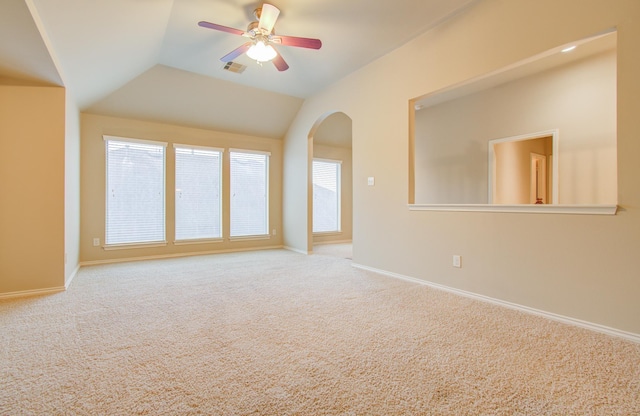 carpeted empty room with vaulted ceiling and ceiling fan