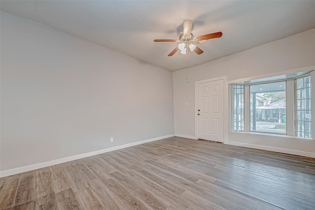 empty room featuring ceiling fan and light wood-type flooring