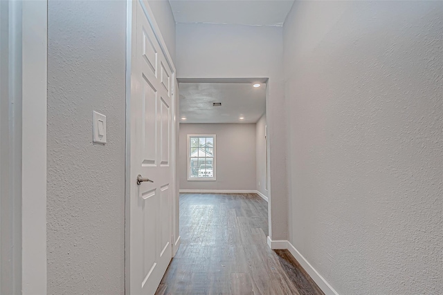 hall with wood-type flooring