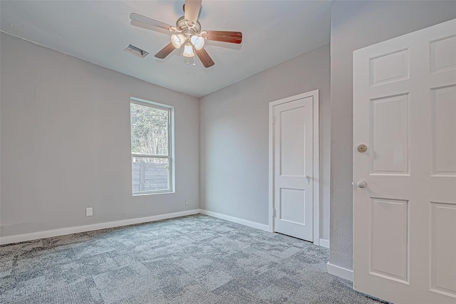 spare room featuring ceiling fan and light carpet