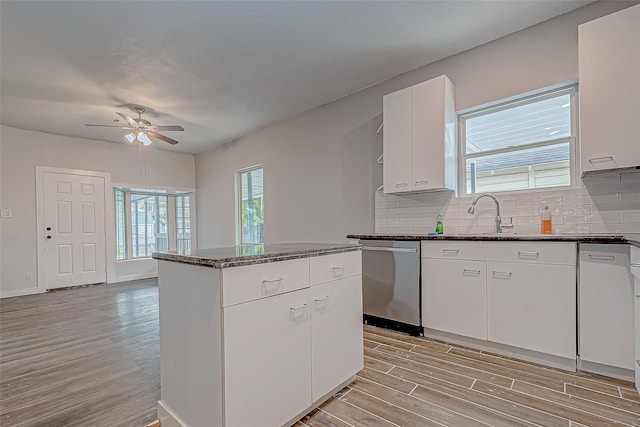 kitchen featuring light wood-type flooring, stainless steel dishwasher, ceiling fan, sink, and white cabinetry