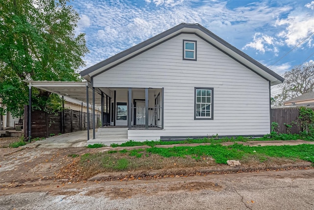 view of front facade with a porch and a carport