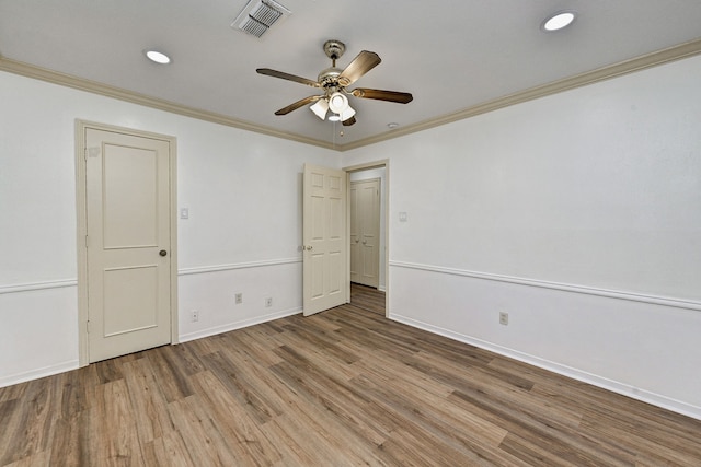 unfurnished bedroom featuring hardwood / wood-style flooring, ornamental molding, and ceiling fan