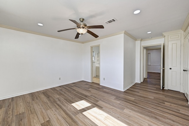 unfurnished room with hardwood / wood-style floors, crown molding, and ceiling fan