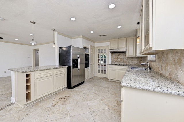 kitchen featuring tasteful backsplash, sink, hanging light fixtures, black appliances, and light stone countertops