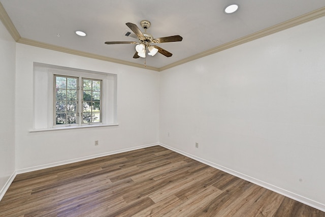 spare room featuring dark wood-type flooring, ornamental molding, and ceiling fan