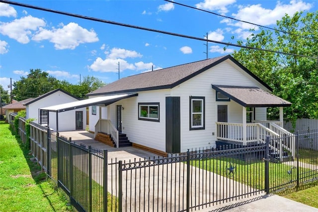 bungalow-style home featuring covered porch and a front lawn