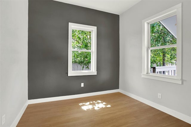 empty room with hardwood / wood-style floors