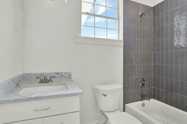 full bathroom with vanity, toilet, and tiled shower / bath combo