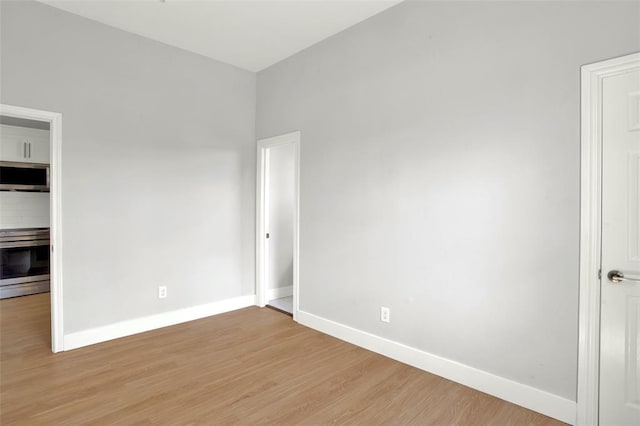 spare room with light wood-type flooring