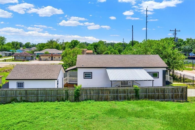 rear view of property featuring a yard