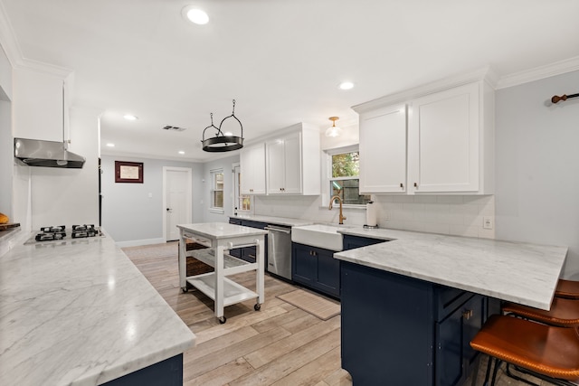 kitchen featuring sink, a breakfast bar area, light stone countertops, white cabinets, and stainless steel dishwasher