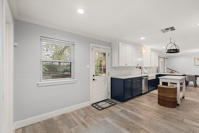 kitchen featuring blue cabinets, white cabinetry, stainless steel dishwasher, and light hardwood / wood-style flooring