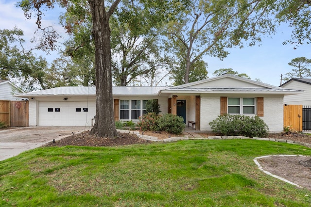 single story home with a front lawn and a garage