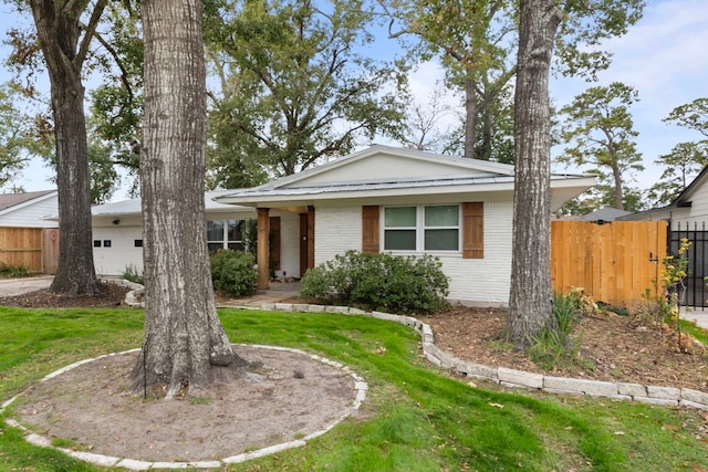 ranch-style home with a front lawn and a garage