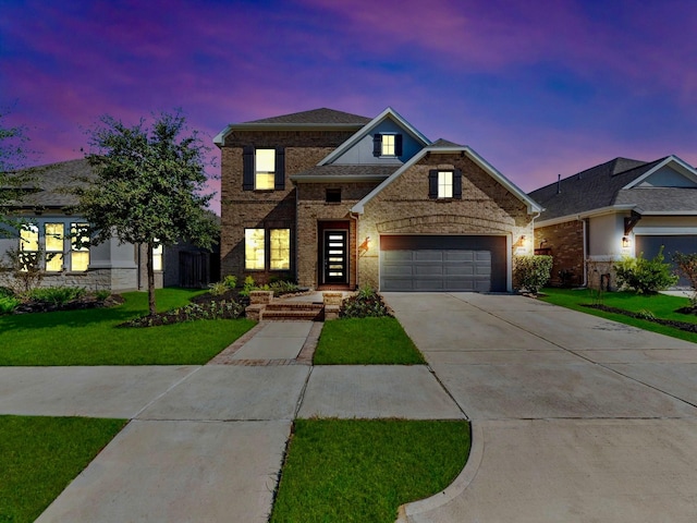 view of front of house with a yard and a garage