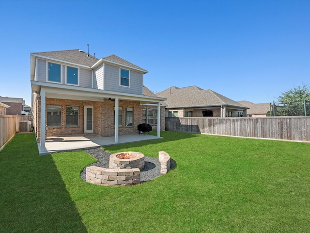 back of property featuring ceiling fan, a patio, cooling unit, and a lawn