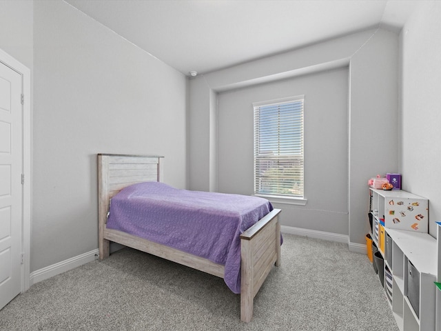 bedroom featuring baseboards and light colored carpet