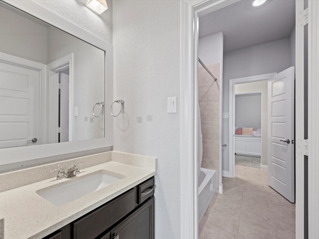 full bath with shower / bathtub combination, vanity, and tile patterned floors