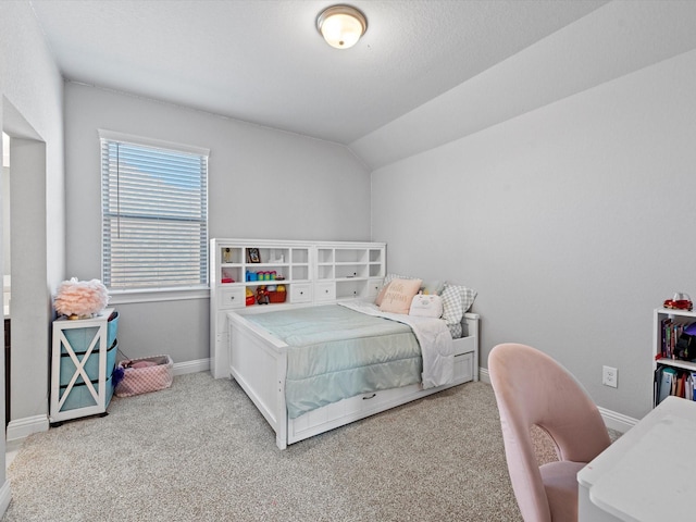 carpeted bedroom featuring lofted ceiling and baseboards