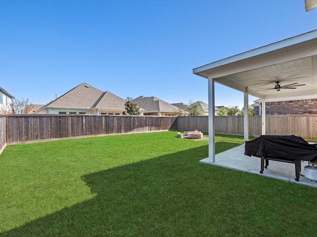 view of yard with ceiling fan, a patio area, and a fenced backyard