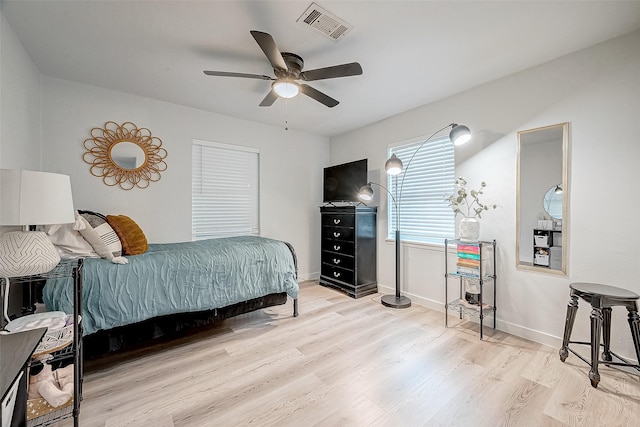 bedroom with ceiling fan and light hardwood / wood-style floors