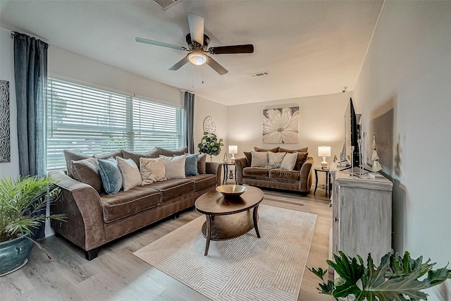 living room featuring light hardwood / wood-style floors and ceiling fan