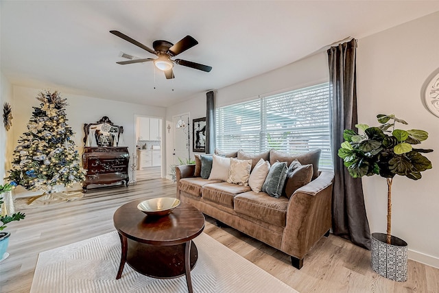 living room featuring ceiling fan and light wood-type flooring