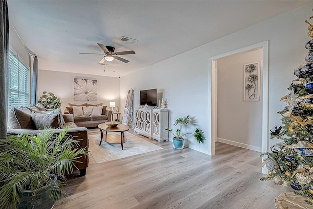 living room featuring light hardwood / wood-style floors and ceiling fan