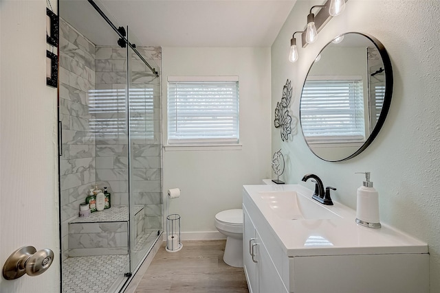 bathroom featuring hardwood / wood-style flooring, vanity, toilet, and an enclosed shower