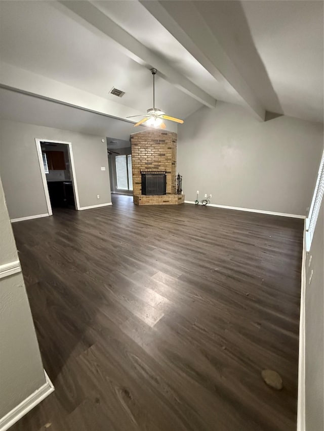 unfurnished living room with dark wood-type flooring, a fireplace, and lofted ceiling with beams