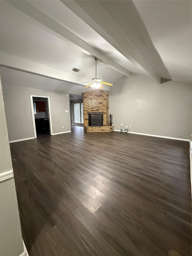 unfurnished living room featuring a fireplace, lofted ceiling with beams, ceiling fan, and dark wood-type flooring