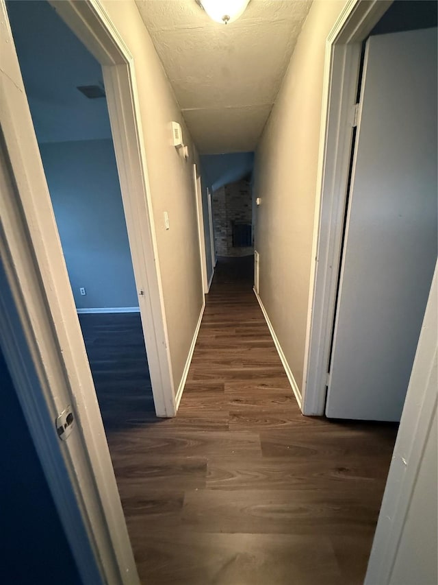 corridor with dark hardwood / wood-style floors