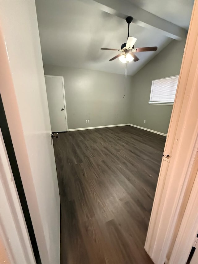 unfurnished room featuring vaulted ceiling with beams, dark hardwood / wood-style floors, and ceiling fan