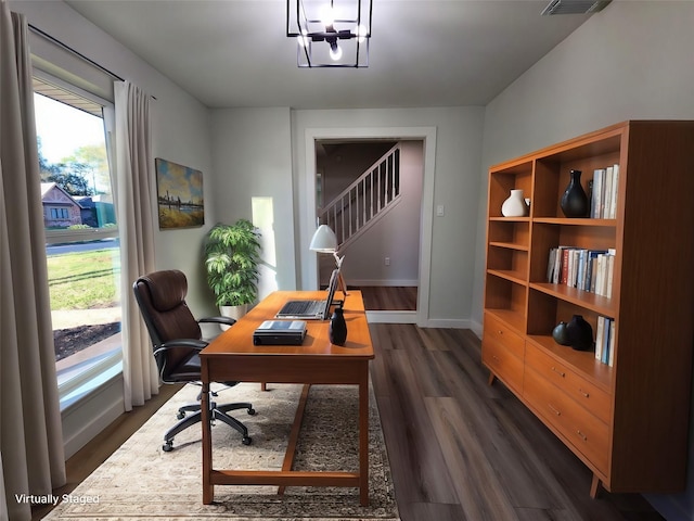 office space featuring dark hardwood / wood-style flooring and an inviting chandelier