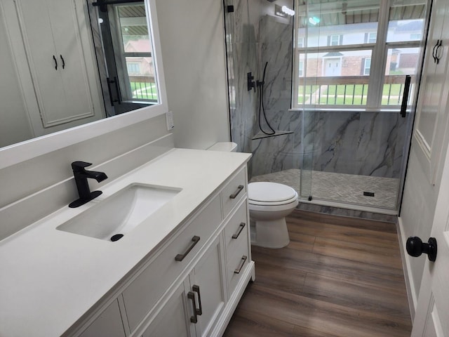 bathroom with vanity, hardwood / wood-style flooring, toilet, and walk in shower