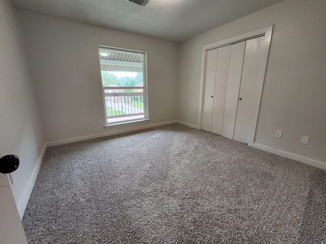 unfurnished bedroom with carpet and a closet