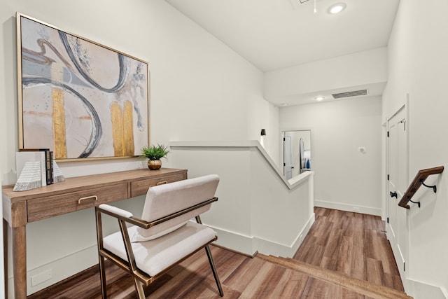 stairs featuring hardwood / wood-style floors