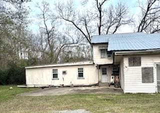 rear view of house featuring a yard