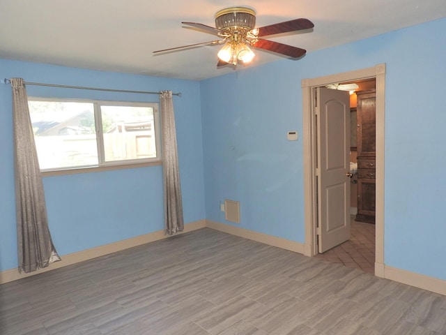 empty room featuring light hardwood / wood-style floors and ceiling fan