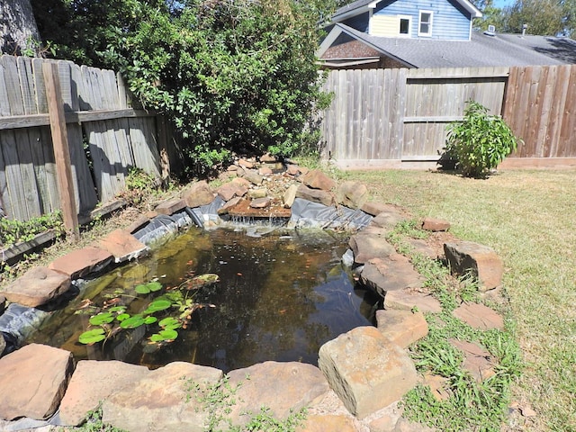 view of yard with a garden pond