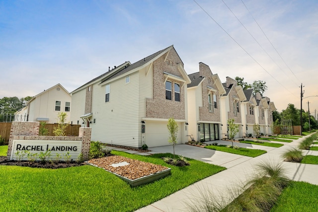 view of front of property featuring a garage and a front yard