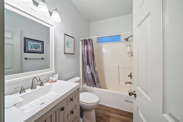 full bathroom featuring hardwood / wood-style floors, vanity, shower / tub combo, and toilet