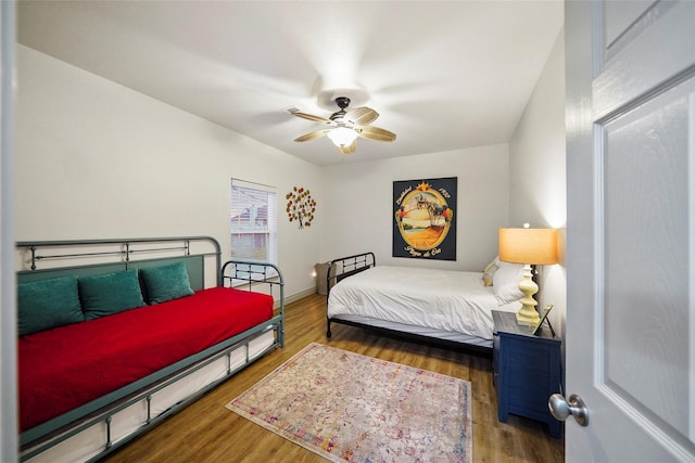 bedroom with ceiling fan and dark wood-type flooring