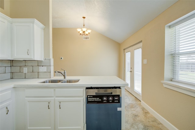 kitchen with dishwashing machine, decorative backsplash, sink, and white cabinetry