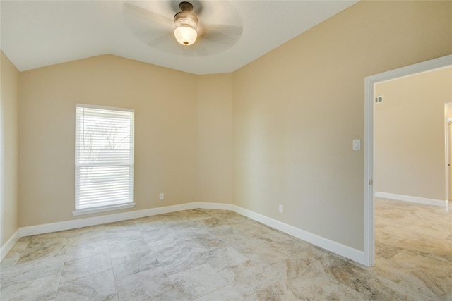 empty room with ceiling fan and vaulted ceiling