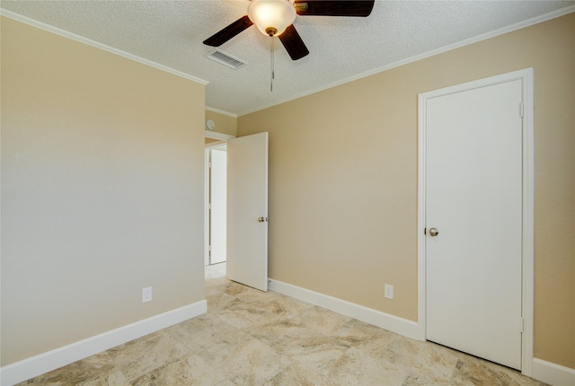 unfurnished room featuring ceiling fan, crown molding, and a textured ceiling