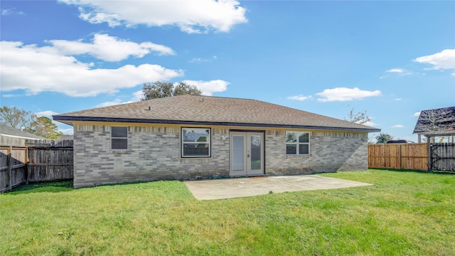 rear view of house featuring french doors, a patio area, and a yard