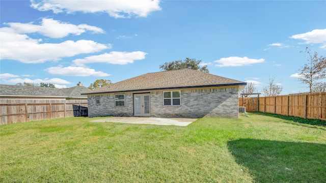 back of house featuring central air condition unit, a lawn, and a patio