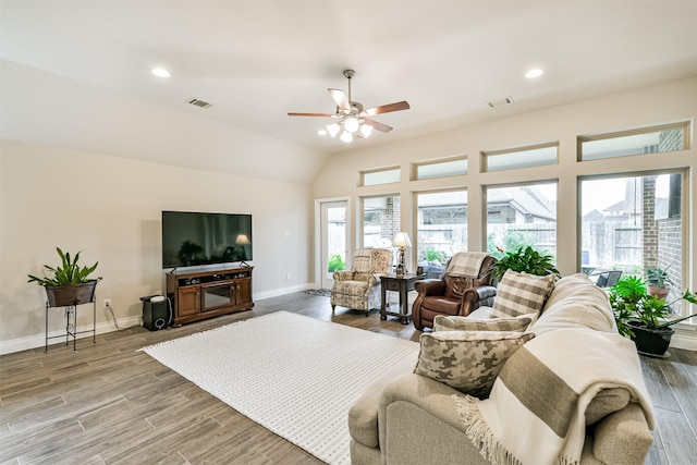 living room featuring hardwood / wood-style flooring, ceiling fan, and vaulted ceiling